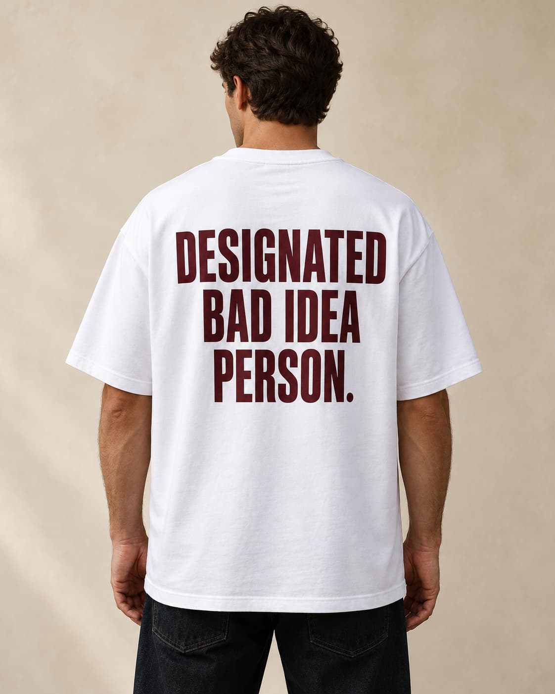 Oversized Tee in white. Caption reads: Designated Bad Idea Person.