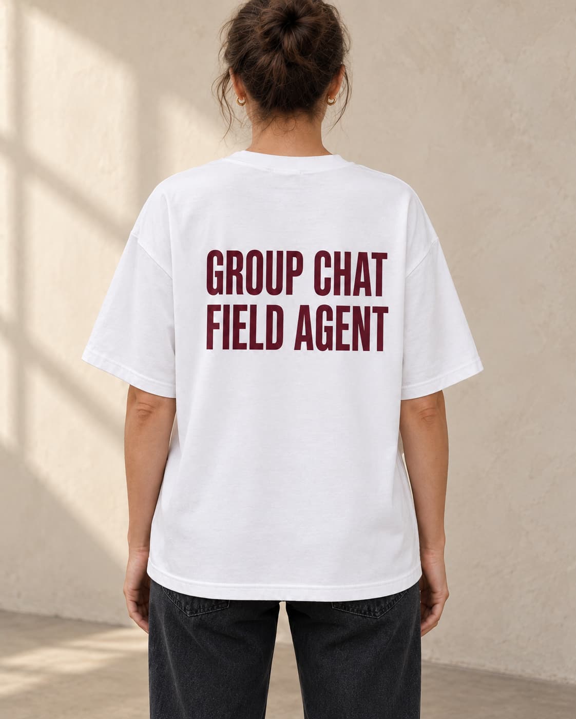 Oversized Tee in white. Caption reads: Group Chat Field Agent