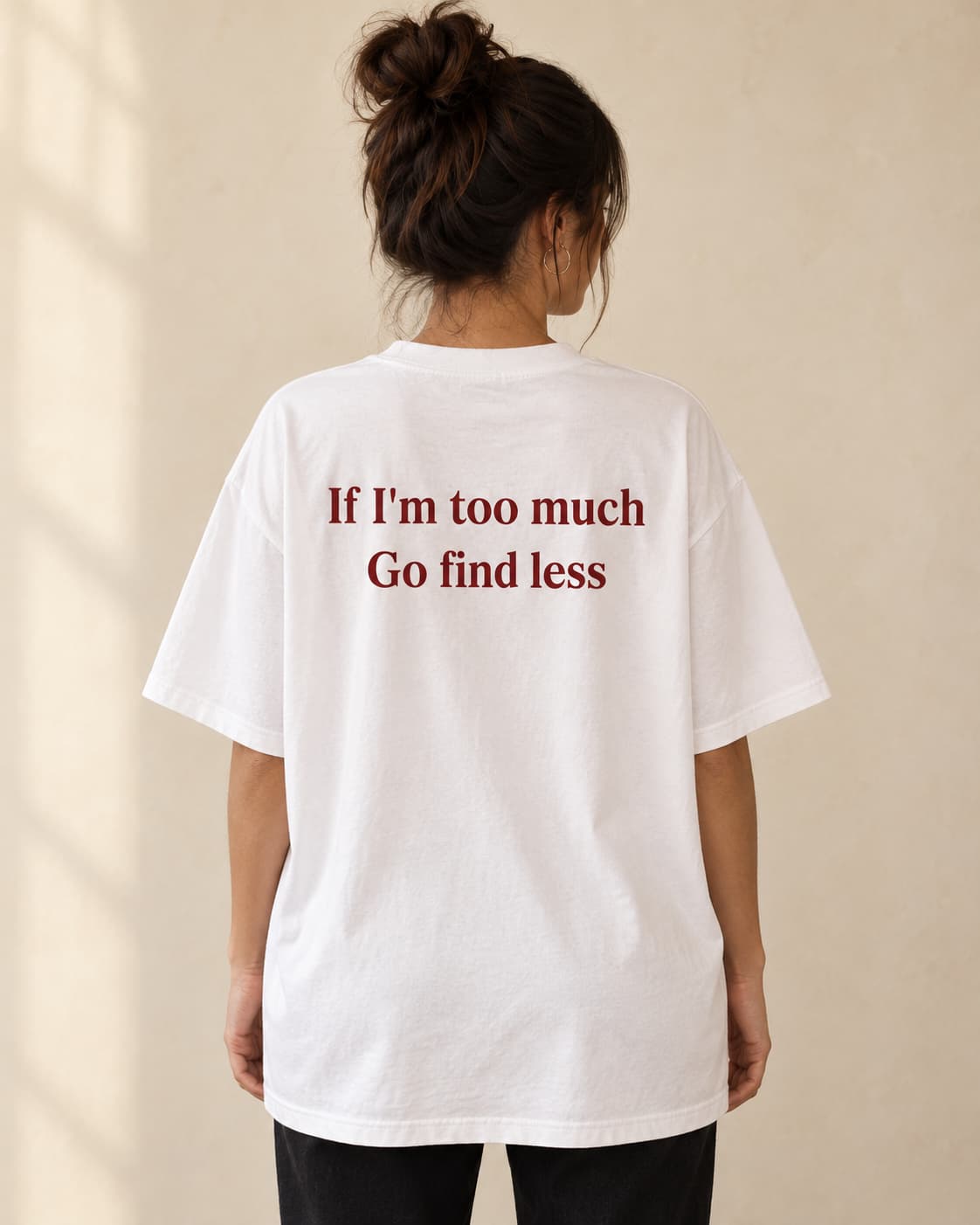 Oversized Tee in white. Caption reads: If I'm too much Go find less