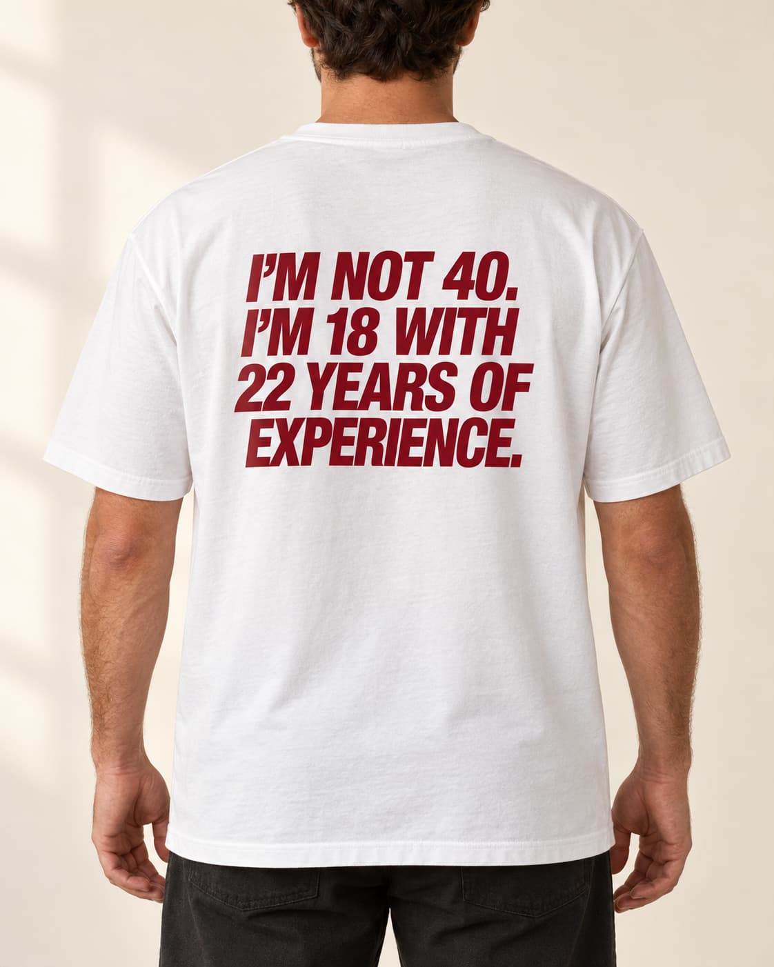 Oversized Tee in white. Caption reads: I'M NOT 40. I'M 18 WITH 22 YEARS OF EXPERIENCE.