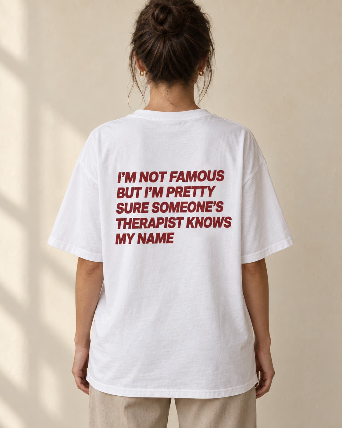 Oversized Tee in white. Caption reads: I’M NOT FAMOUS BUT I’M PRETTY SURE SOMEONE’S THERAPIST KNOWS MY NAME