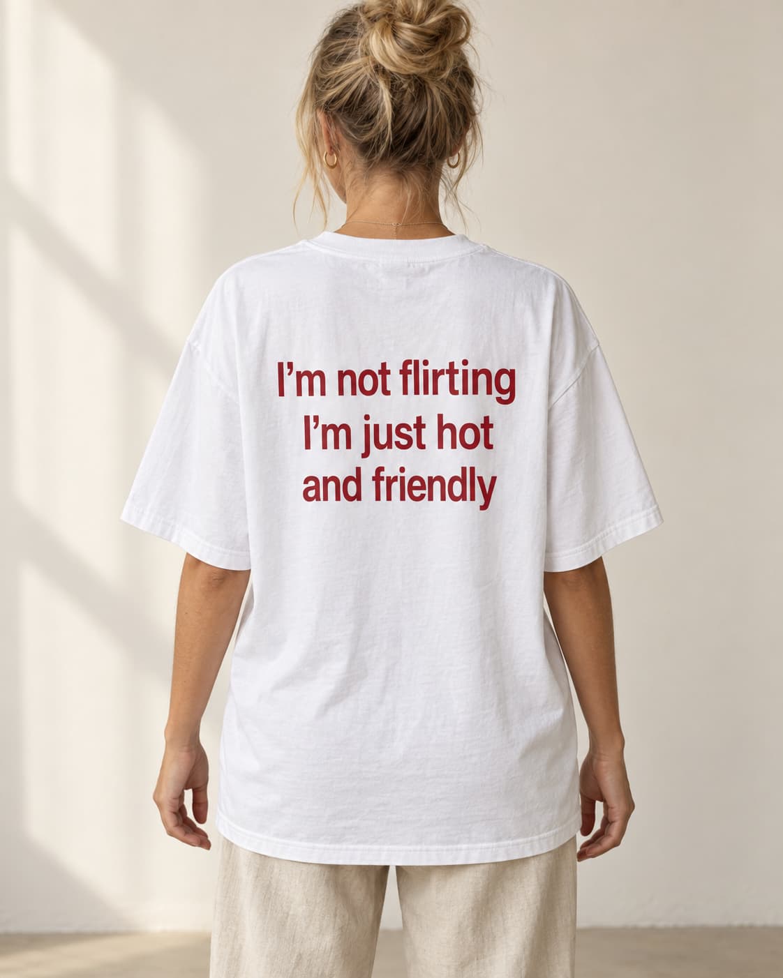 Oversized Tee in white. Caption reads: I’m not flirting I’m just hot and friendly