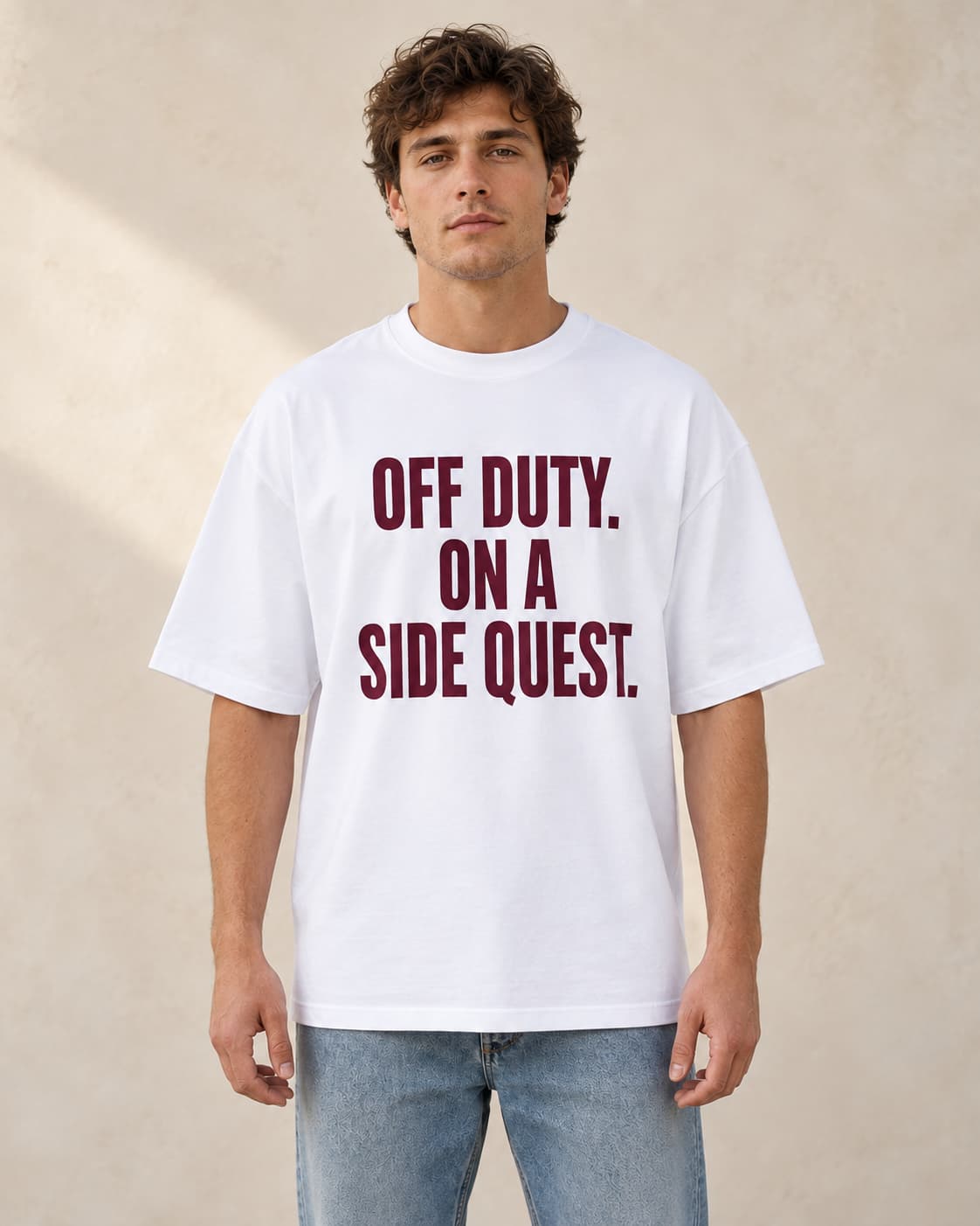 Oversized Tee in white. Caption reads: Off Duty. On A Side Quest.