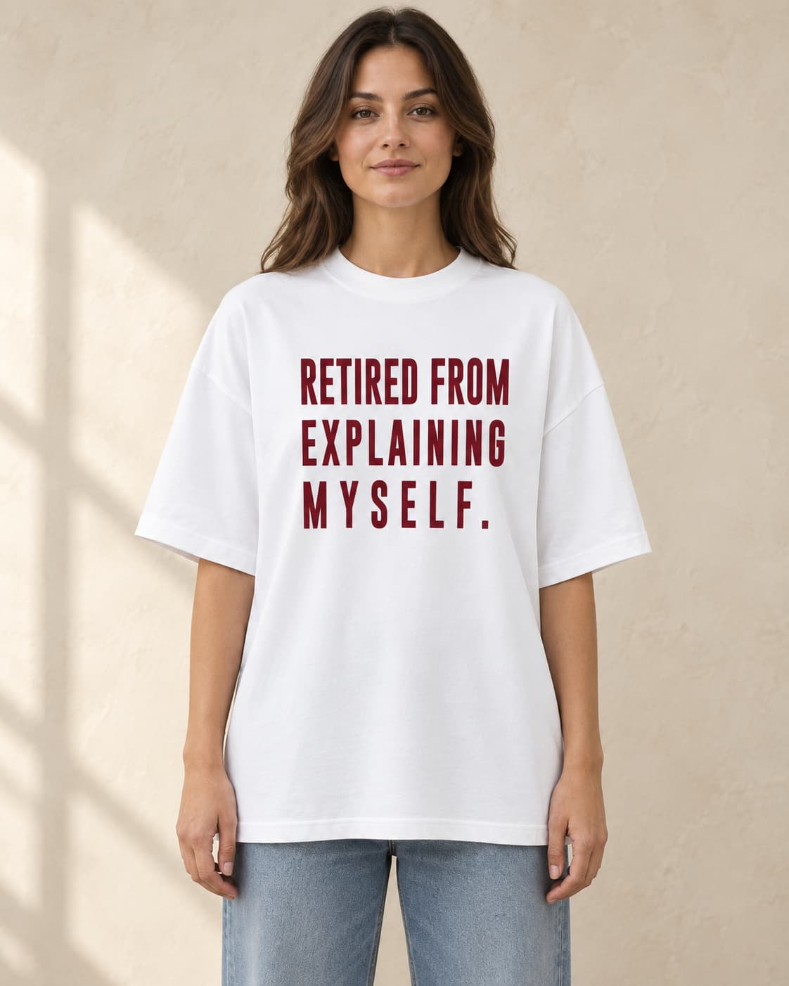 Oversized Tee in white. Caption reads: Retired From Explaining Myself.