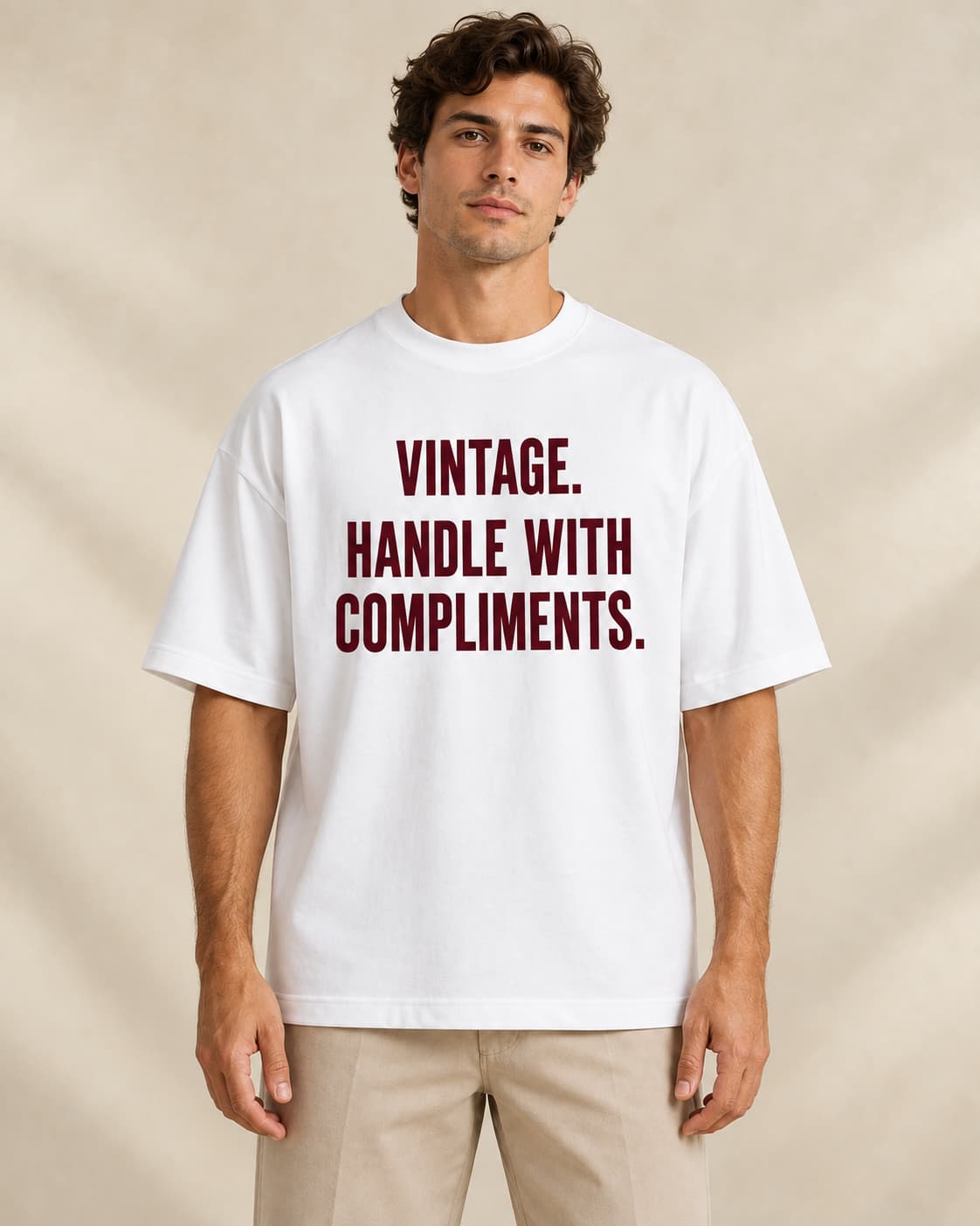 Oversized Tee in white. Caption reads: Vintage. Handle With Compliments.